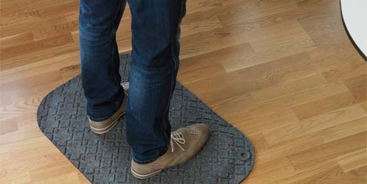 A person standing on top of a floor mat.