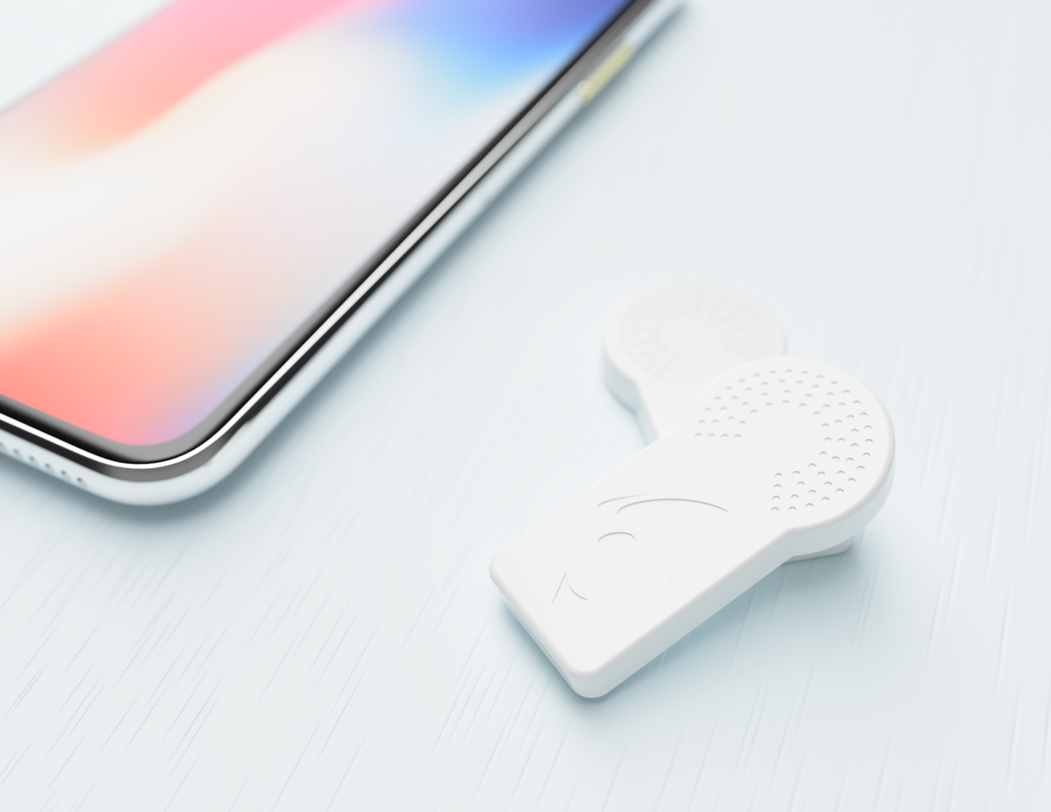 Two Fibion SENS Motion Wearable Sensors on a Table next to iPhone X