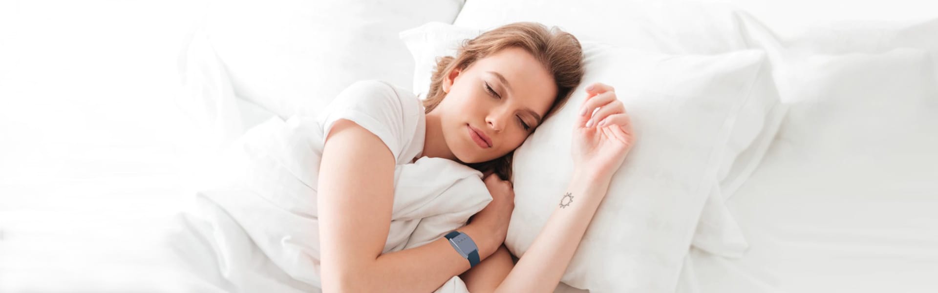 woman sleeping with fibion sleep device on the wrist