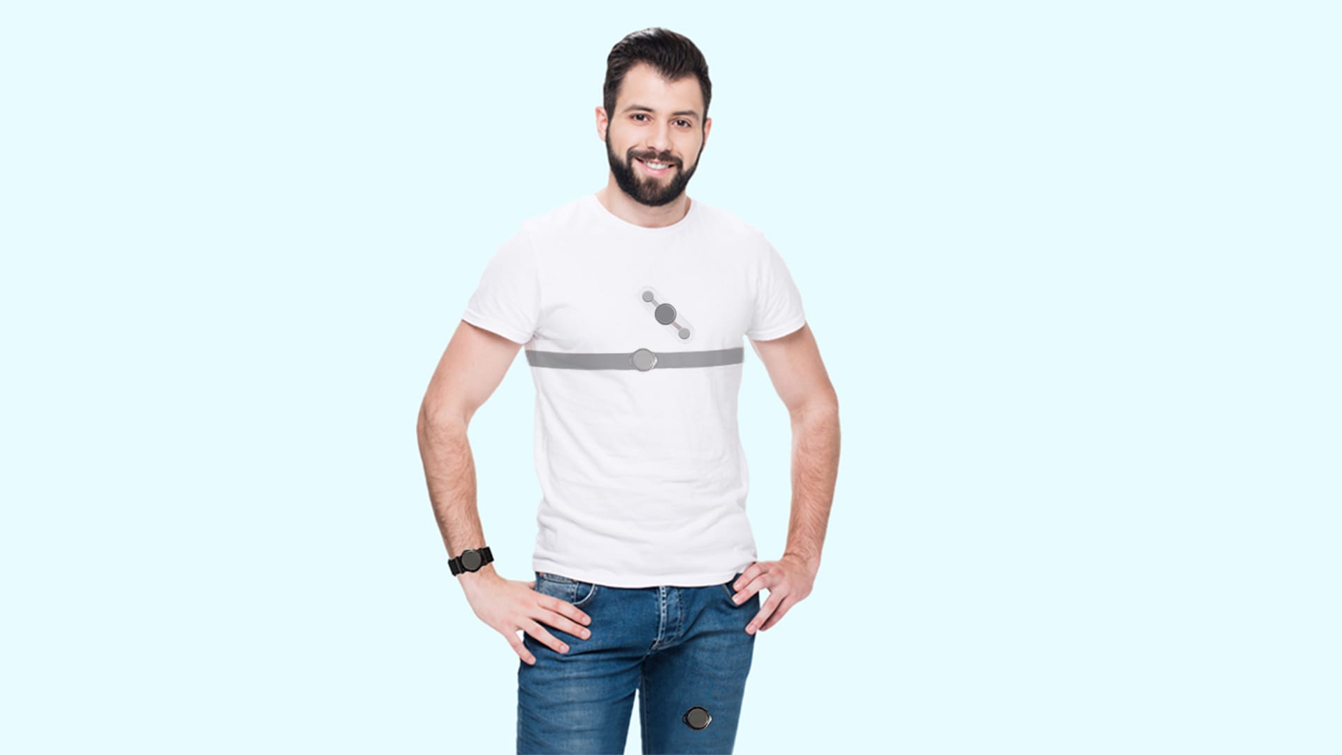 A man with a beard, wearing a white t-shirt featuring a gray geometric Flash design, blue jeans, and a smartwatch monitoring HRV, stands confidently with his hands on his hips against a light blue background.