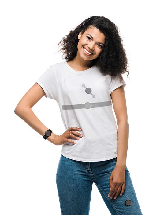 A person with curly hair is smiling, wearing a minimalist white t-shirt and blue jeans, with an Actigraphy Watch on their wrist.