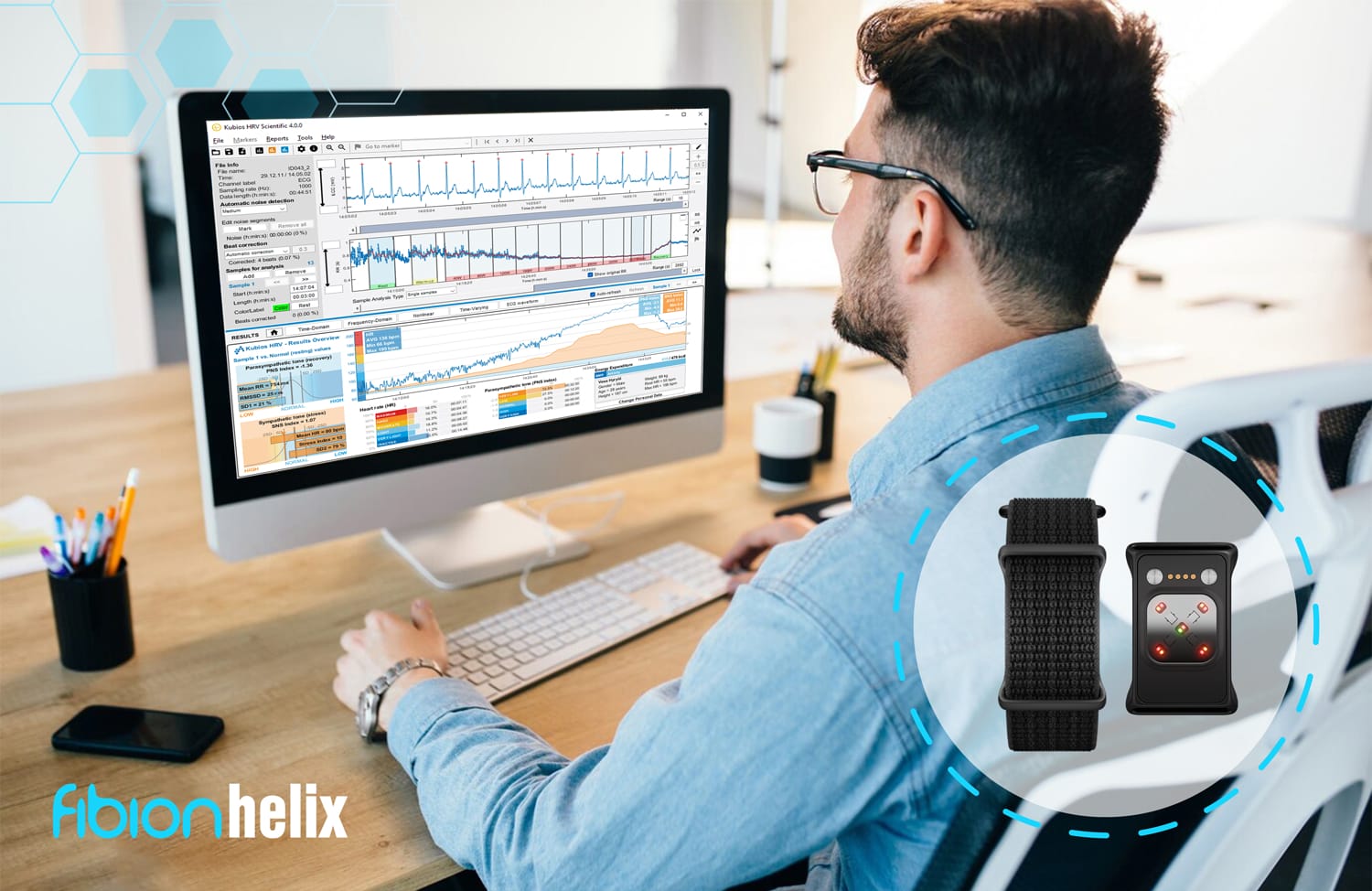 A man sits at a desk analyzing data on a computer screen, with graphics of two smartwatches and their innovative Fibion Helix features displayed next to him.