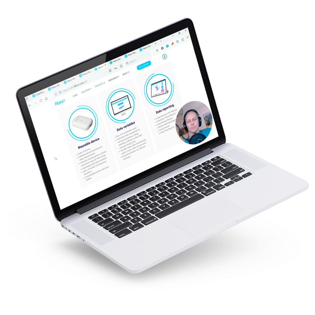 A laptop showcasing the Fibion homepage features sections on wearable devices, data validation, and data reporting, complemented by a video call thumbnail.