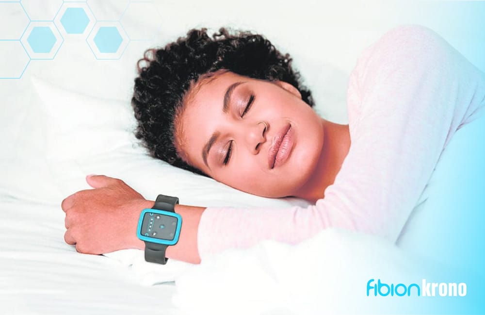 A person peacefully sleeps on a white bed, adorned with a smartwatch. Subtle blue hexagonal patterns enhance the scene, while the "Fibion Krono" logo elegantly graces the corners, blending innovation with tranquility.