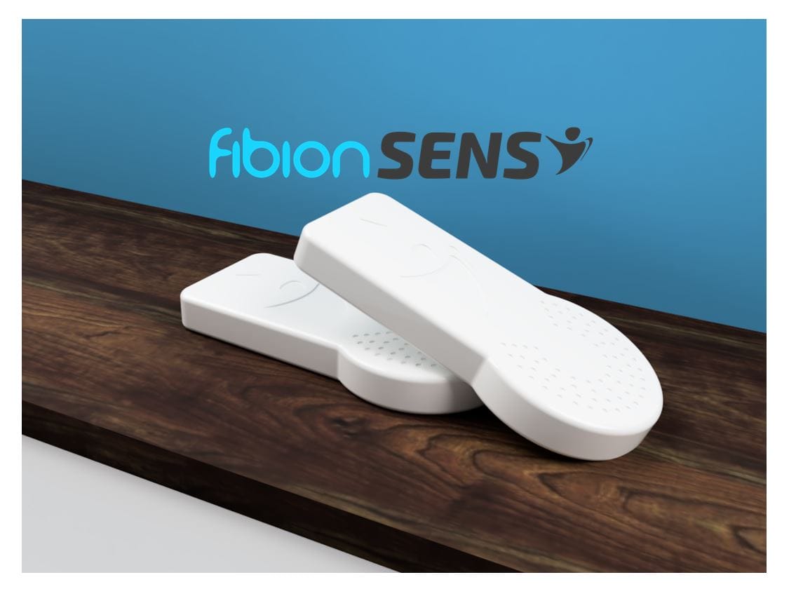 Two white Fibion SENS devices, featuring advanced 9-Axis Motion Sensors, rest on a wooden surface against a blue background adorned with the Fibion SENS logo.