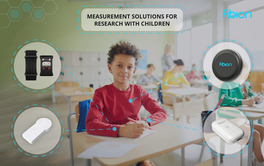 A child in a red shirt sits in a classroom surrounded by colorful illustrations of measurement devices, a part of the researcher's guide for schools focusing on children. In the background, other students are blurred, highlighting this engaging setting.